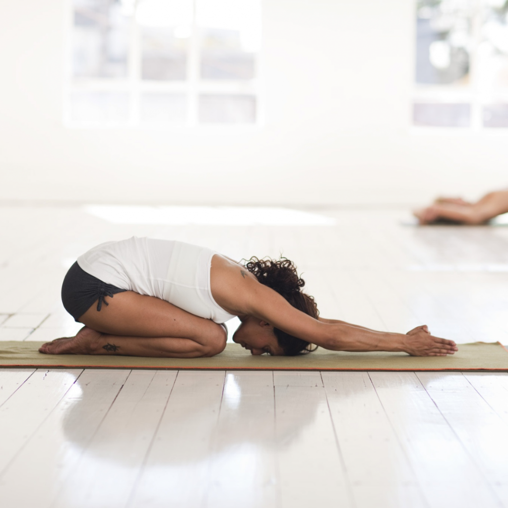Woman doing yoga in a bright studio 